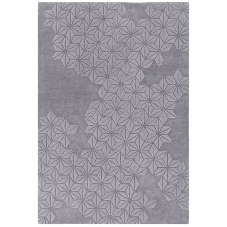 Grey geometric pattern area rug with raised star motifs and textured surface