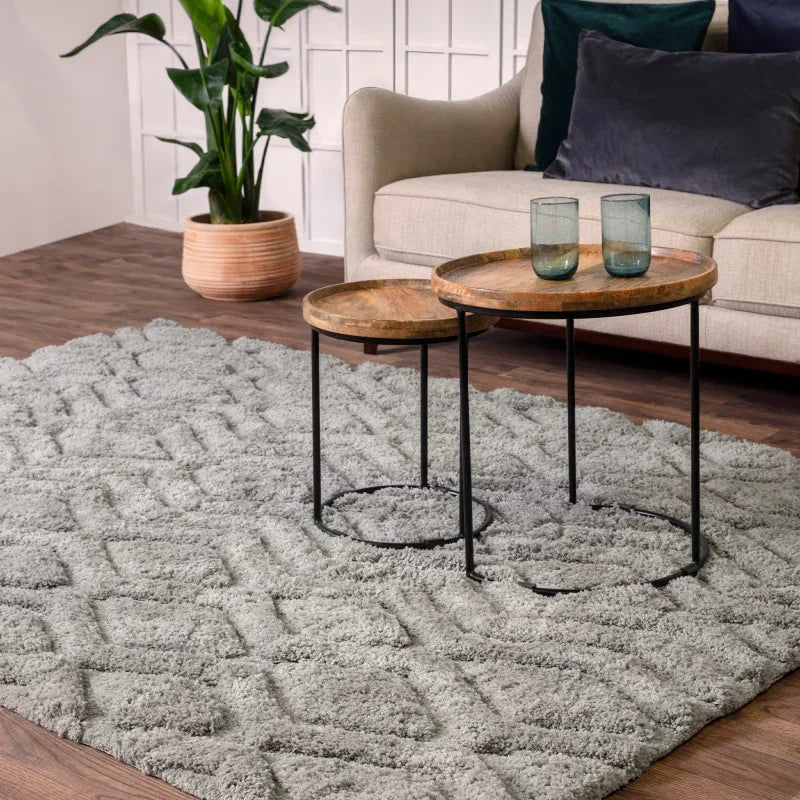 Grey textured rug with geometric pattern and nesting tables in modern living room