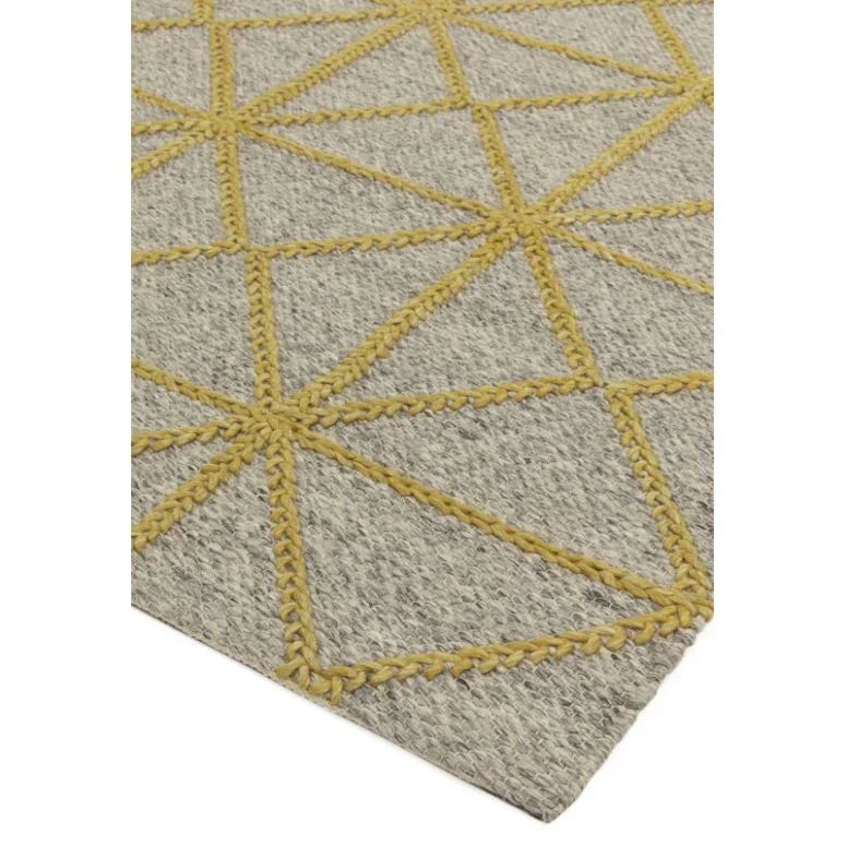 Grey and yellow geometric pattern rug corner detail, textured woven material