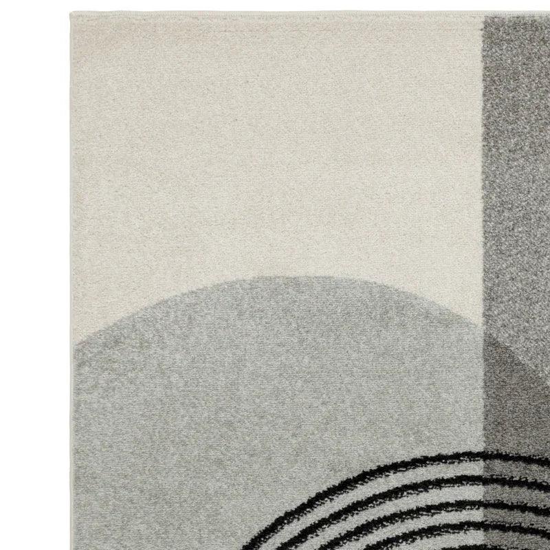 modern area rug with geometric grey and cream pattern, close corner view