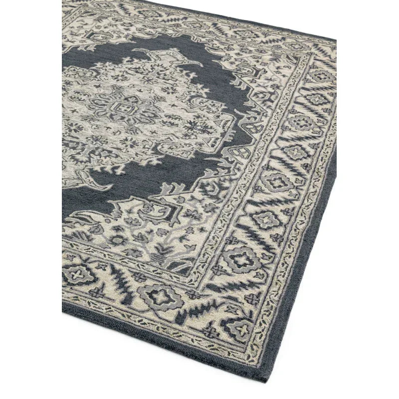 Grey and cream patterned area rug with intricate border design, corner angle view