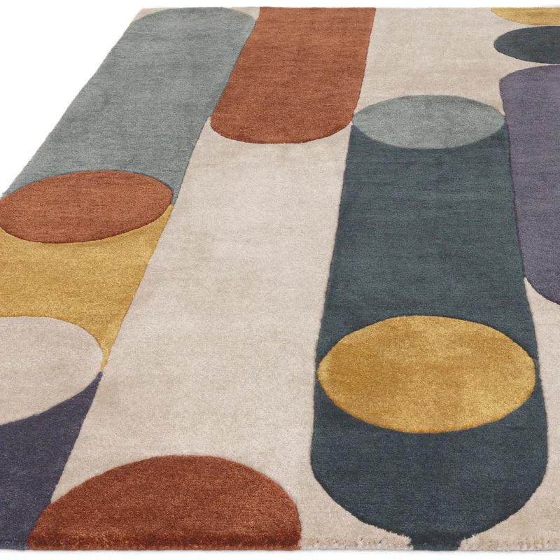Modern area rug with abstract geometric shapes in grey, mustard, rust and cream