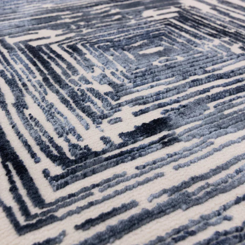 Blue and white geometric pattern rug close up showing textured surface detail