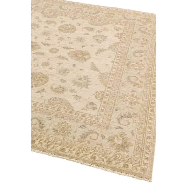 Beige patterned area rug with floral border and intricate woven details