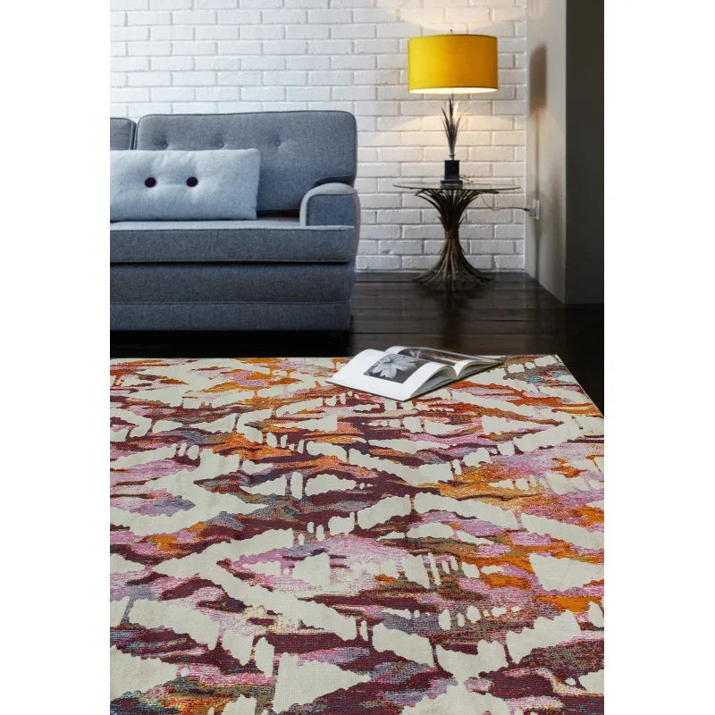 Modern abstract pattern rug in living room with grey sofa and yellow lamp