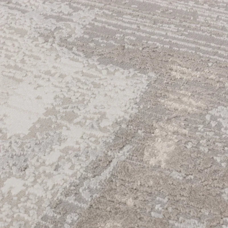 Close view of soft pile area rug with textured grey and cream pattern