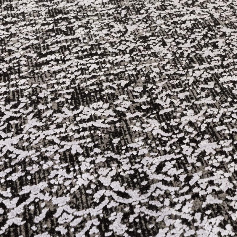 Grey patterned area rug with textured abstract design and soft pile
