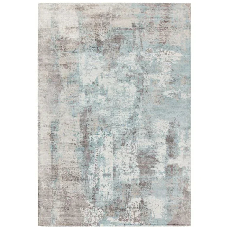 modern abstract area rug with blue and grey tones and distressed texture