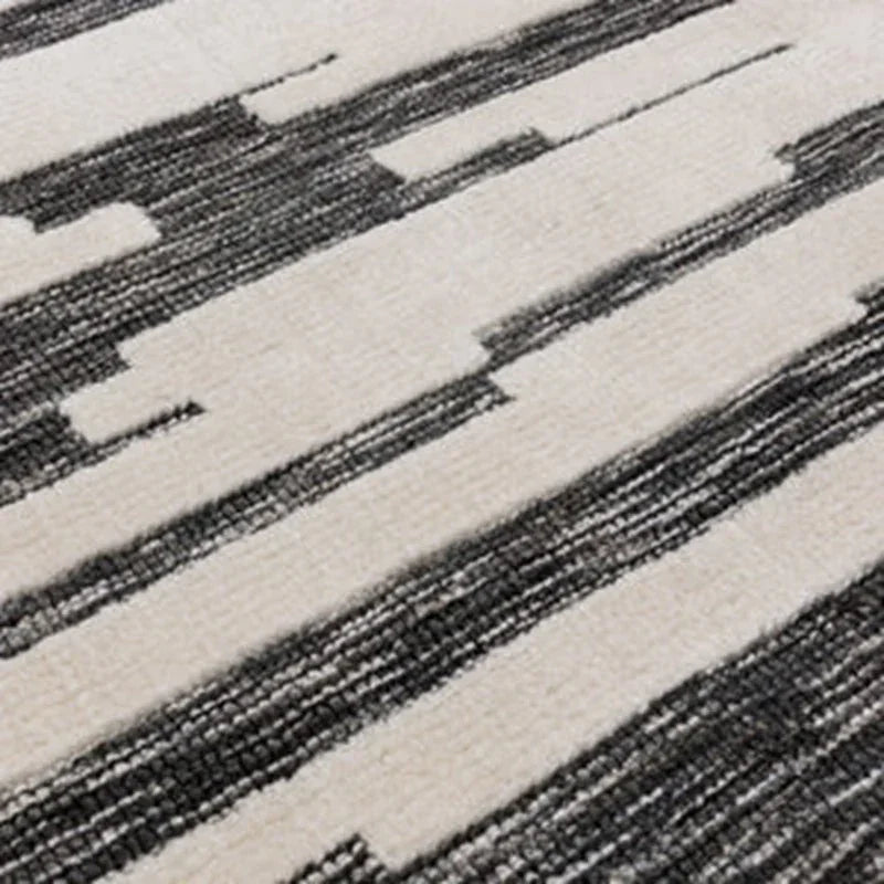 Grey and cream geometric rug with abstract linear pattern, close-up of texture and weave
