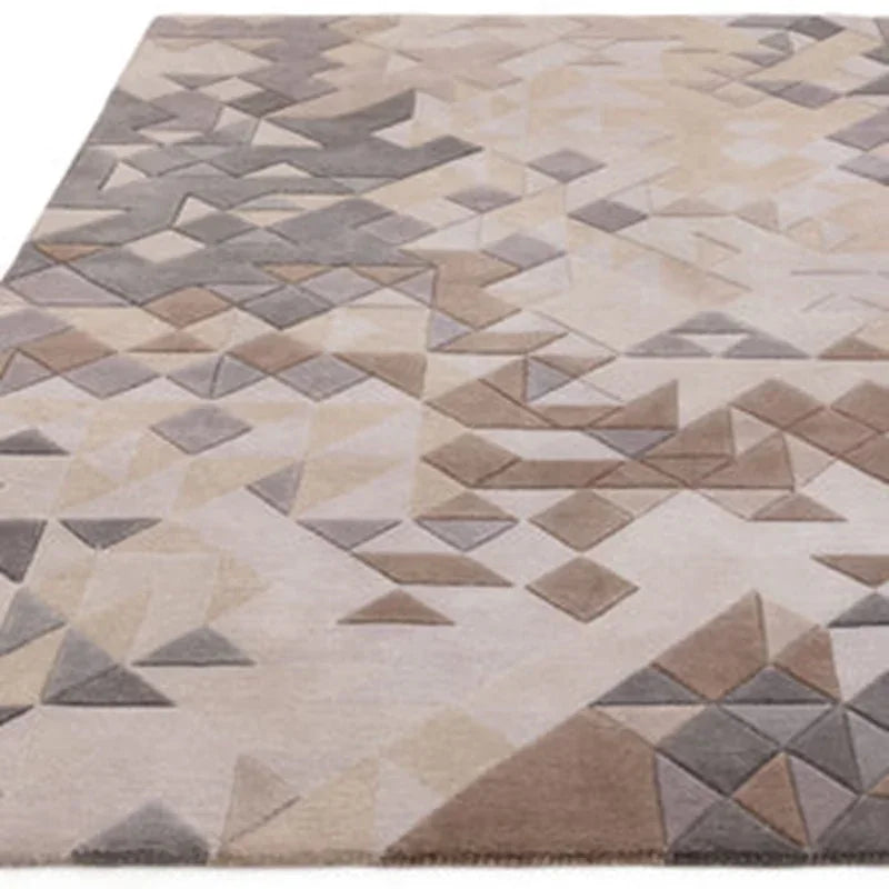Geometric patterned area rug in neutral beige, brown and grey tones on flat surface