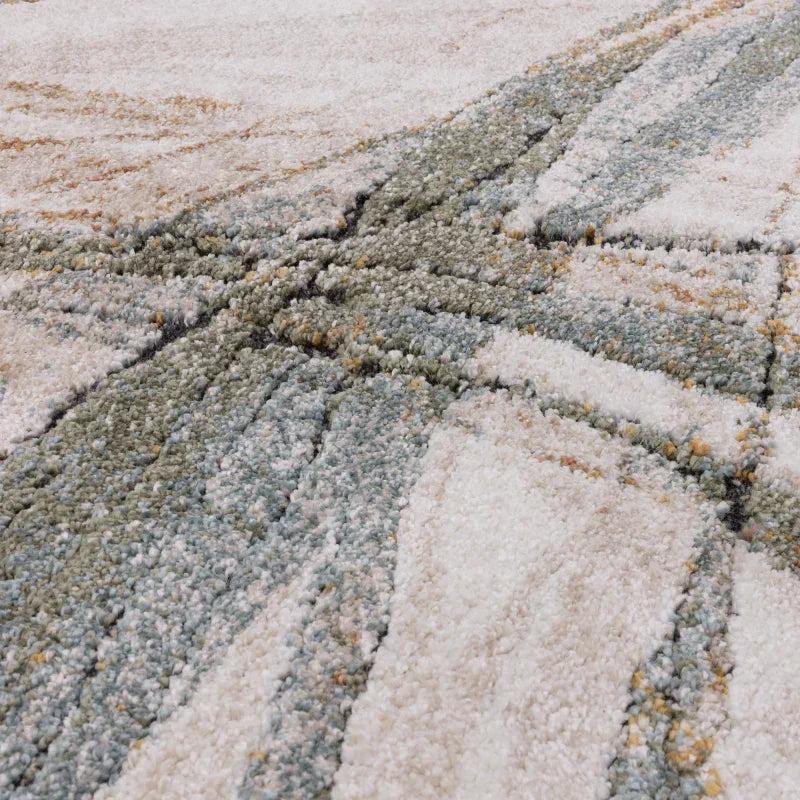 Closeup of textured modern area rug with abstract geometric pattern in cream and sage tones