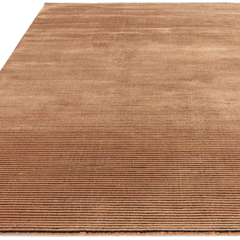 Brown ribbed area rug with textured surface shown from a low angle
