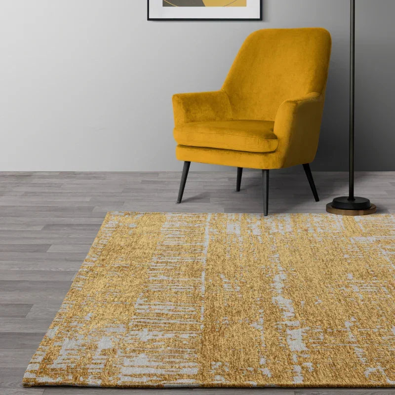 Yellow accent chair and modern yellow area rug on grey wood floor in living room