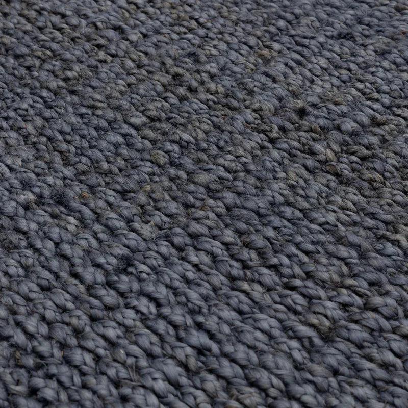 Textured grey woven rug detail with chunky natural fiber weave