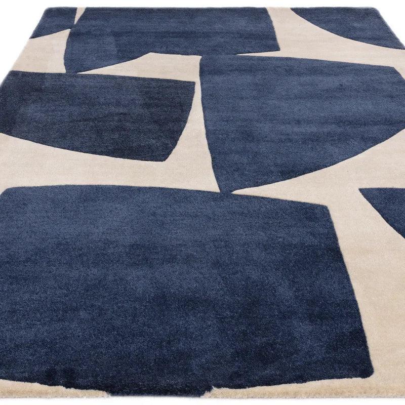 Modern area rug with navy geometric shapes on a cream background, rectangular view