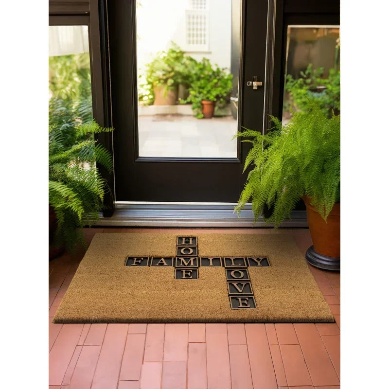 Coir doormat with HOME FAMILY LOVE words at patio door, surrounded by potted ferns