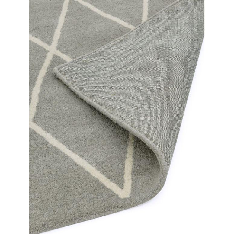 Grey area rug with white geometric pattern and detailed corner fold