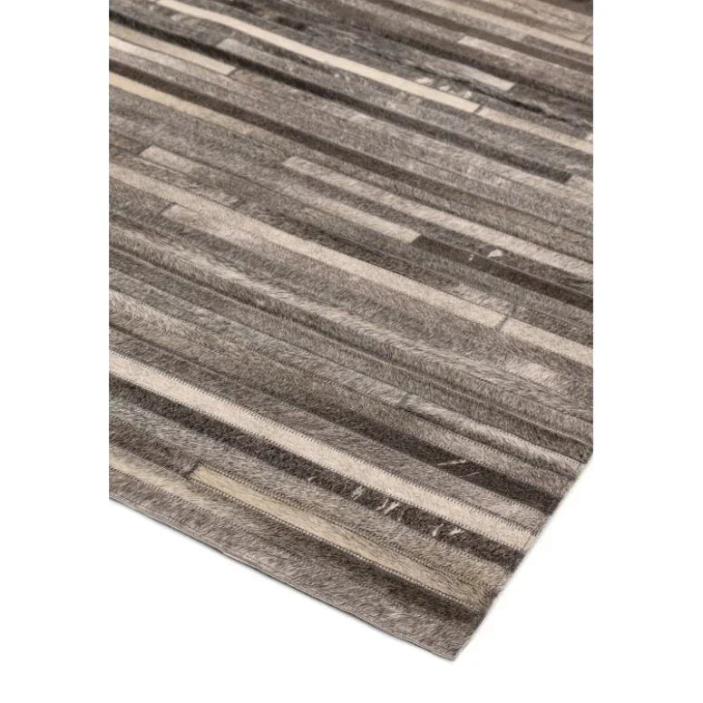 Rectangular grey striped rug with soft textured surface, shown from angled corner view