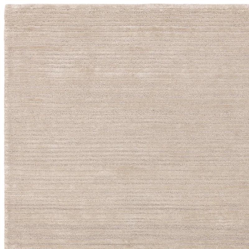 Beige textured area rug with subtle horizontal striped pattern