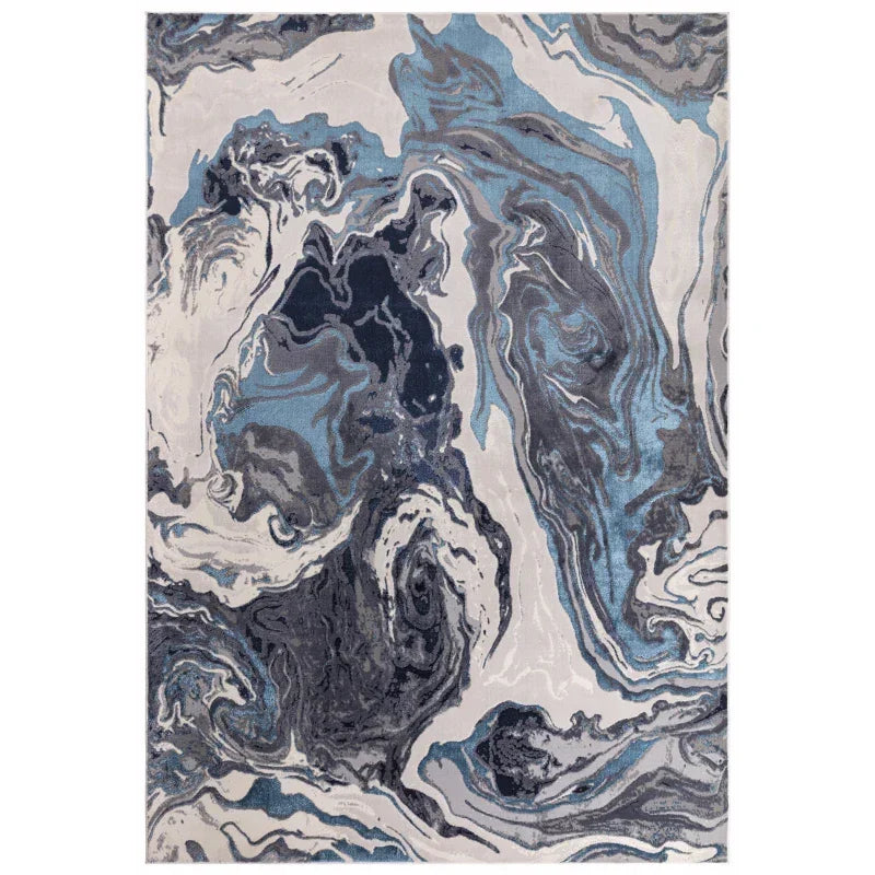 Marble effect area rug with blue, grey, and white abstract swirl pattern