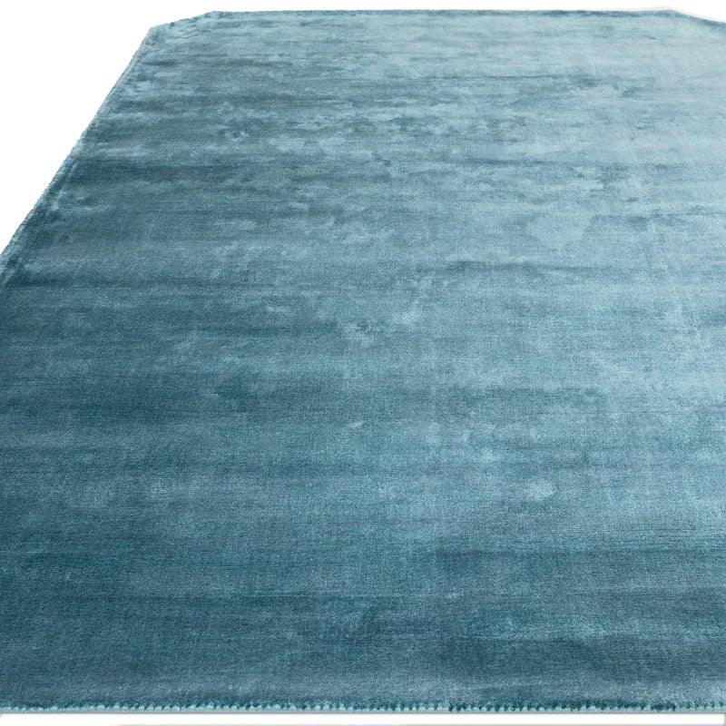 Rectangular teal area rug with soft texture and subtle sheen