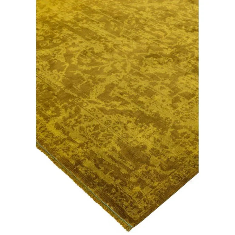 Mustard yellow area rug with textured pattern and finished edge, corner view