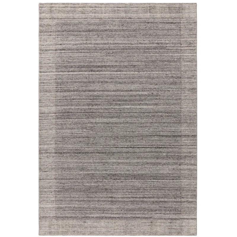 Rectangular grey area rug with subtle textured stripes and a tonal border