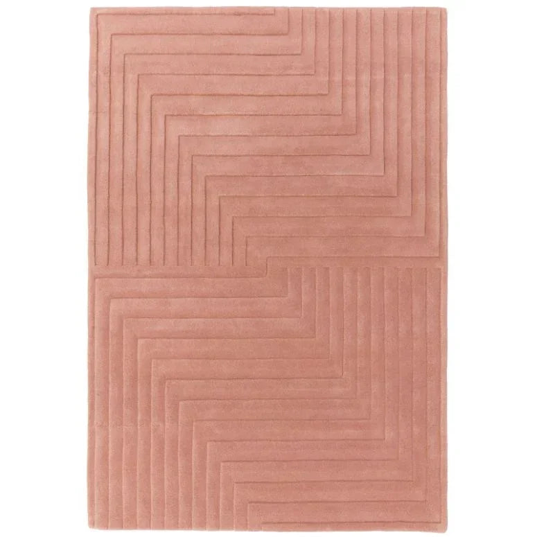 Blush pink area rug with geometric carved pattern and soft texture, top view