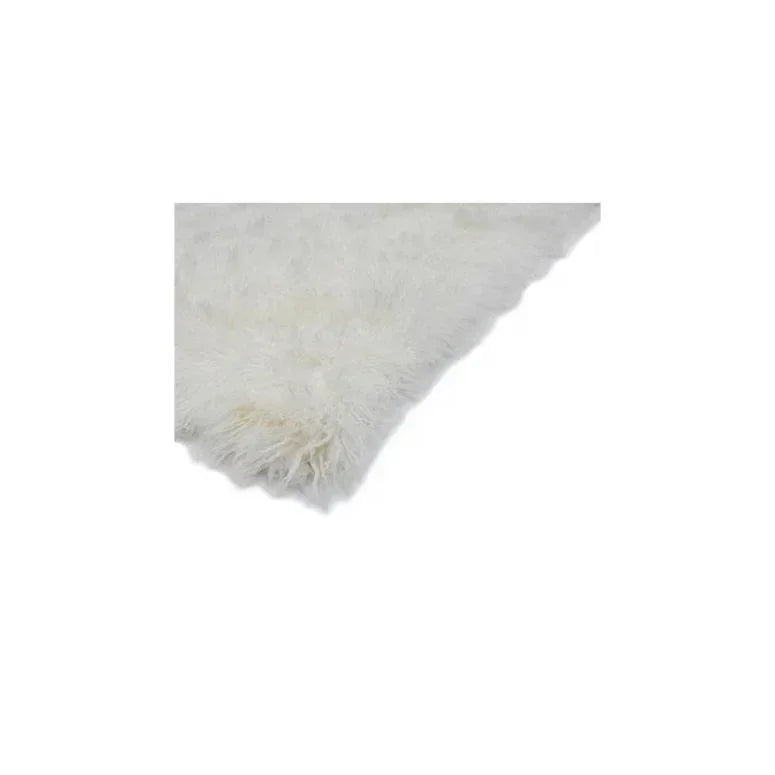 Close-up of white fluffy rug corner showing soft texture and thick pile