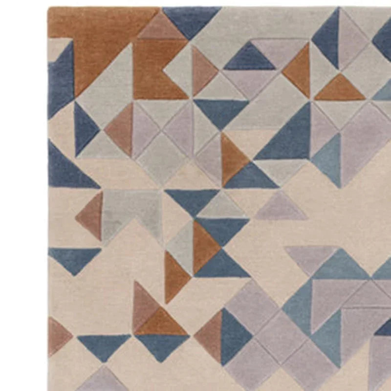 Modern geometric rug with blue, beige, brown and grey triangles and abstract pattern