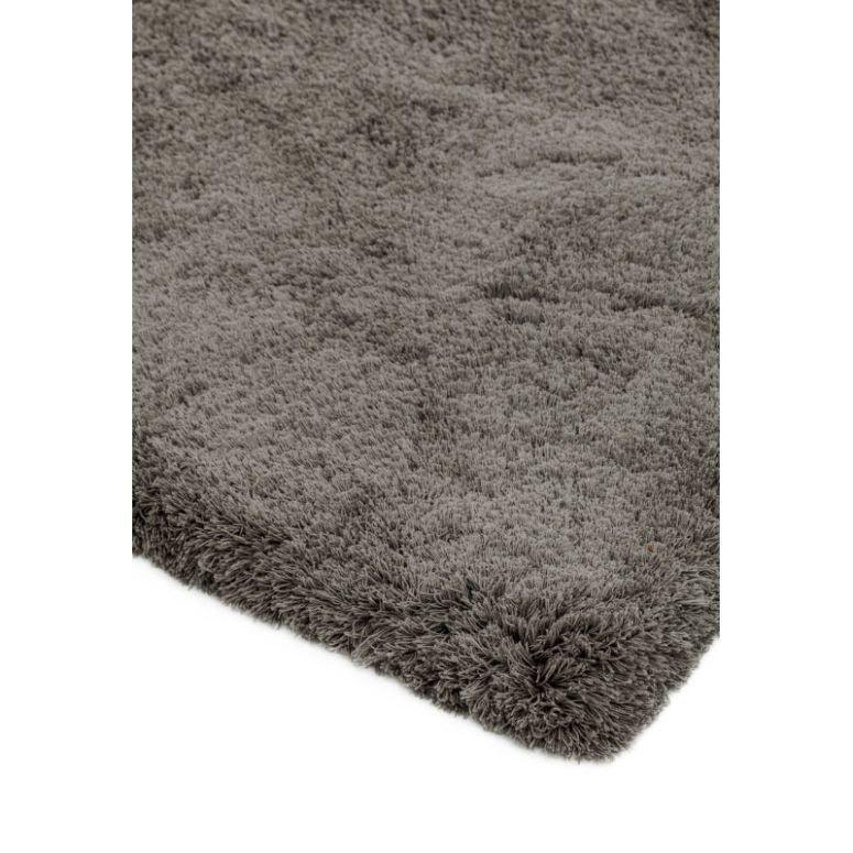 Close-up of grey shaggy rug corner showing soft pile texture