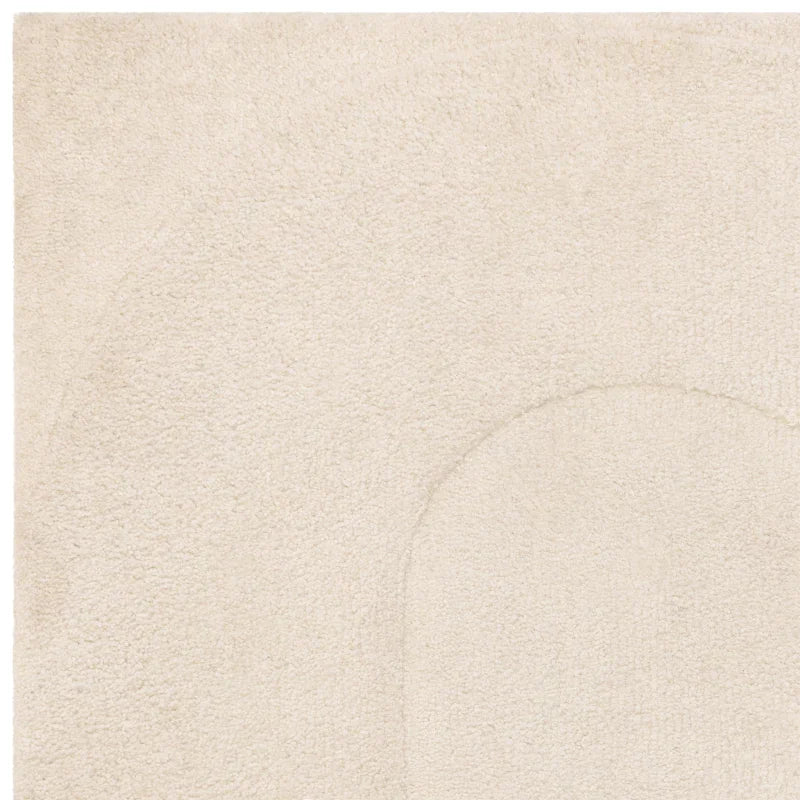 close up of cream textured rug with subtle geometric pattern
