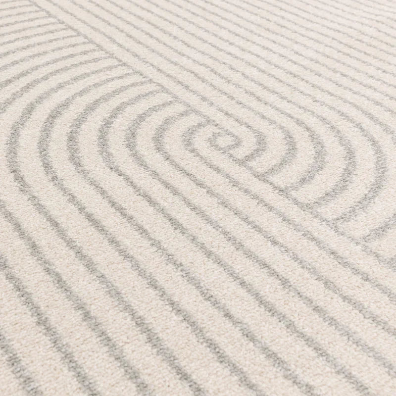 Cream patterned rug with textured grey curved lines, close-up of pile and design
