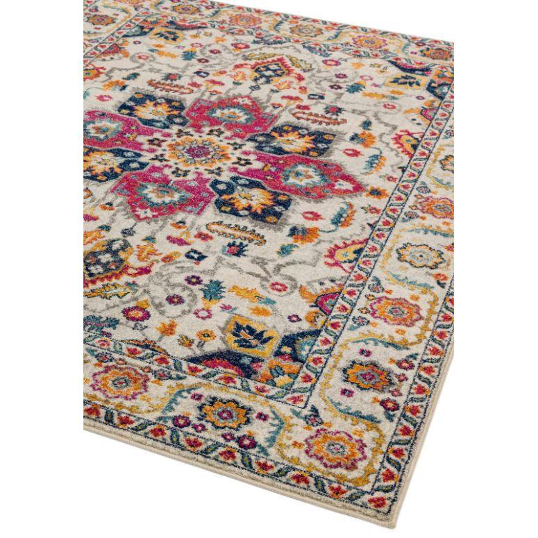 Multicoloured patterned area rug with floral and geometric motifs on cream background
