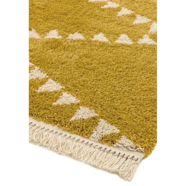 mustard yellow geometric rug with white triangle pattern and fringed edge corner view