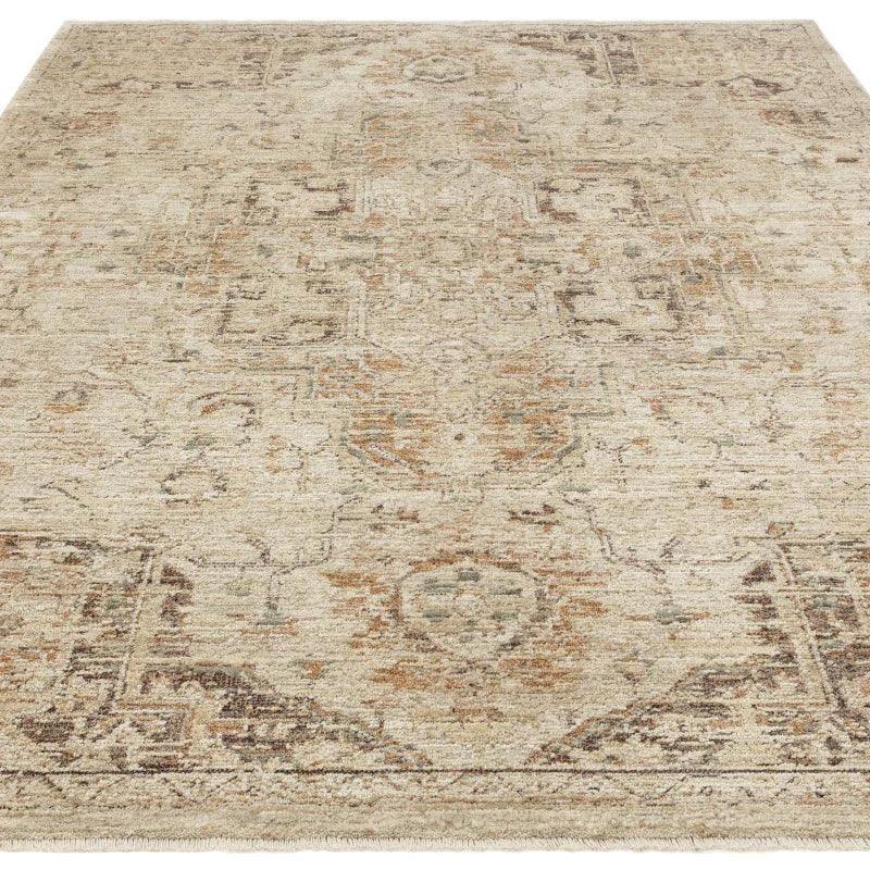 Beige patterned area rug with distressed vintage design and subtle accents