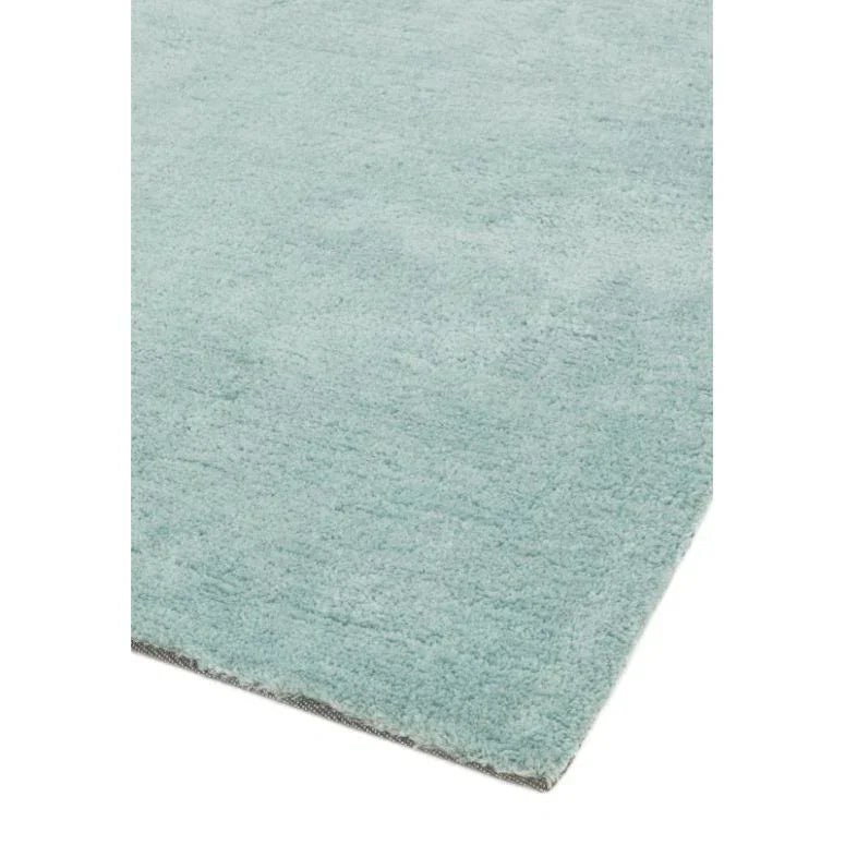 Light blue area rug with soft texture and straight edge closeup