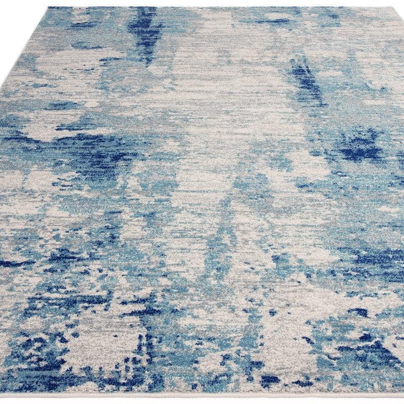 Contemporary blue and white area rug with abstract pattern and textured surface