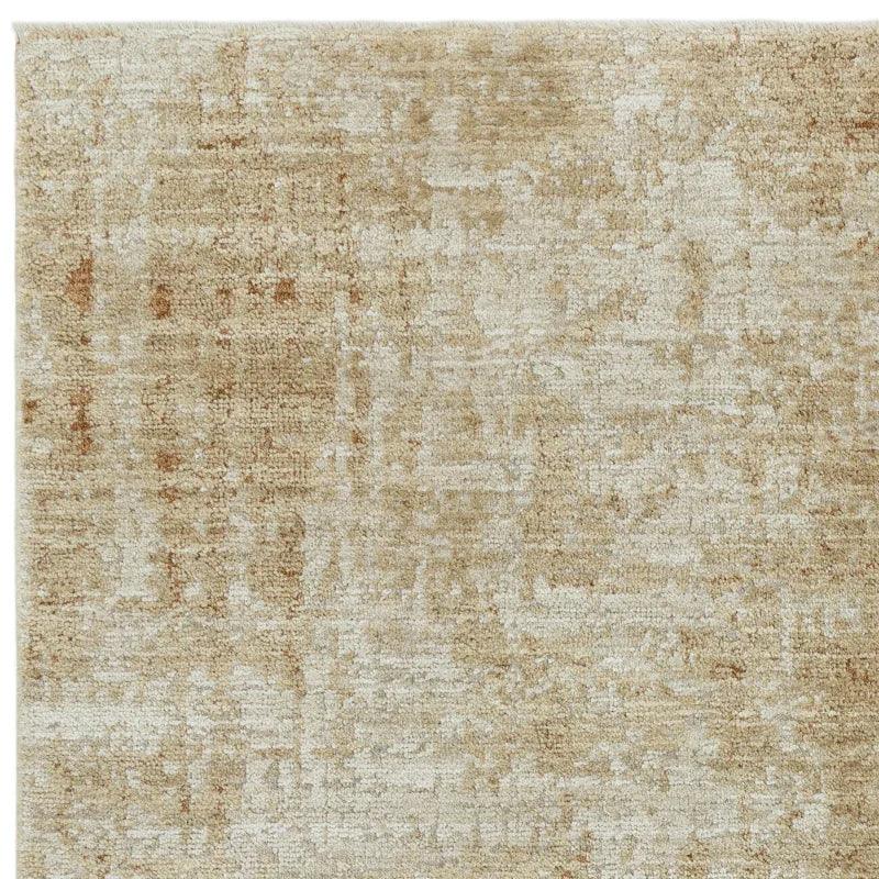 Beige textured area rug with subtle mottled pattern, close-up of corner and surface weave
