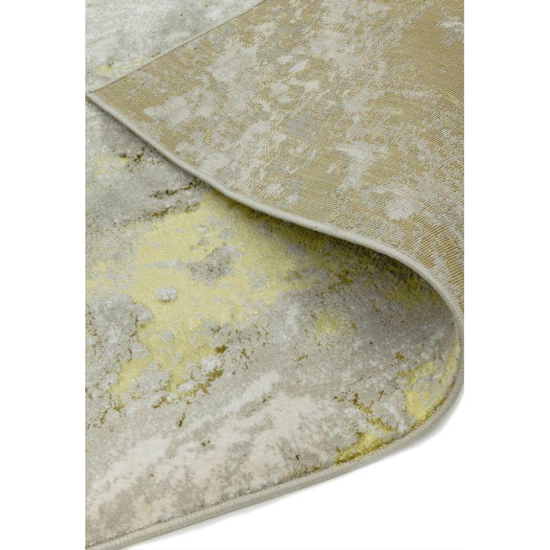 Modern area rug with abstract grey and yellow pattern, close-up of corner and texture