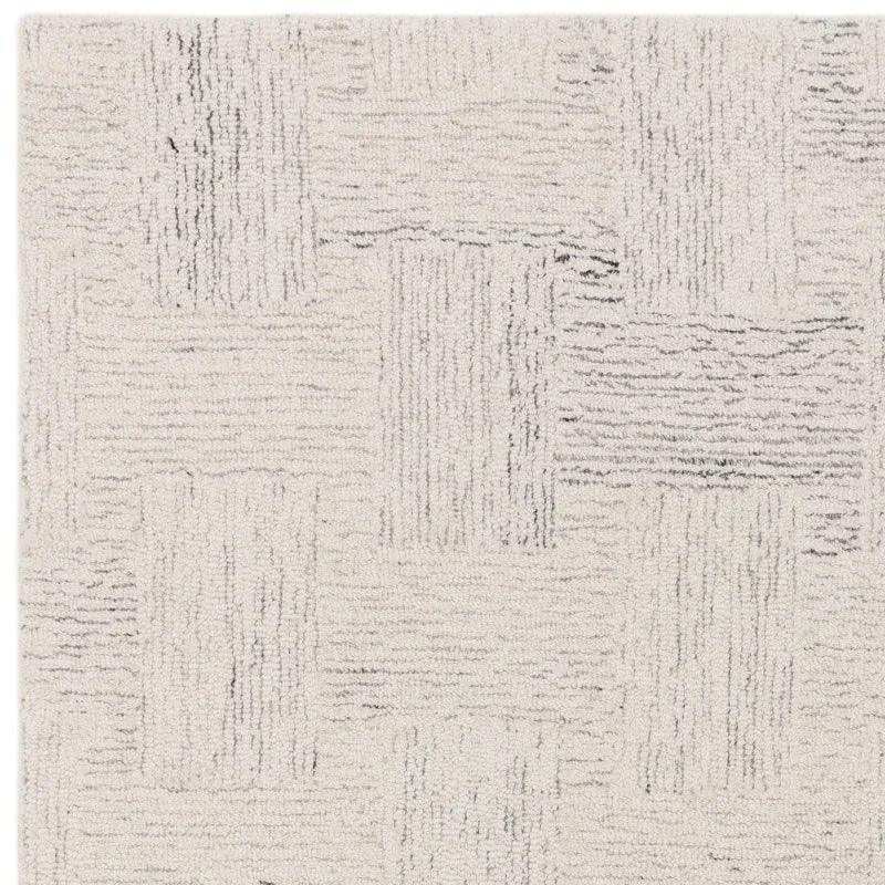 Cream textured area rug with subtle geometric pattern and soft woven pile