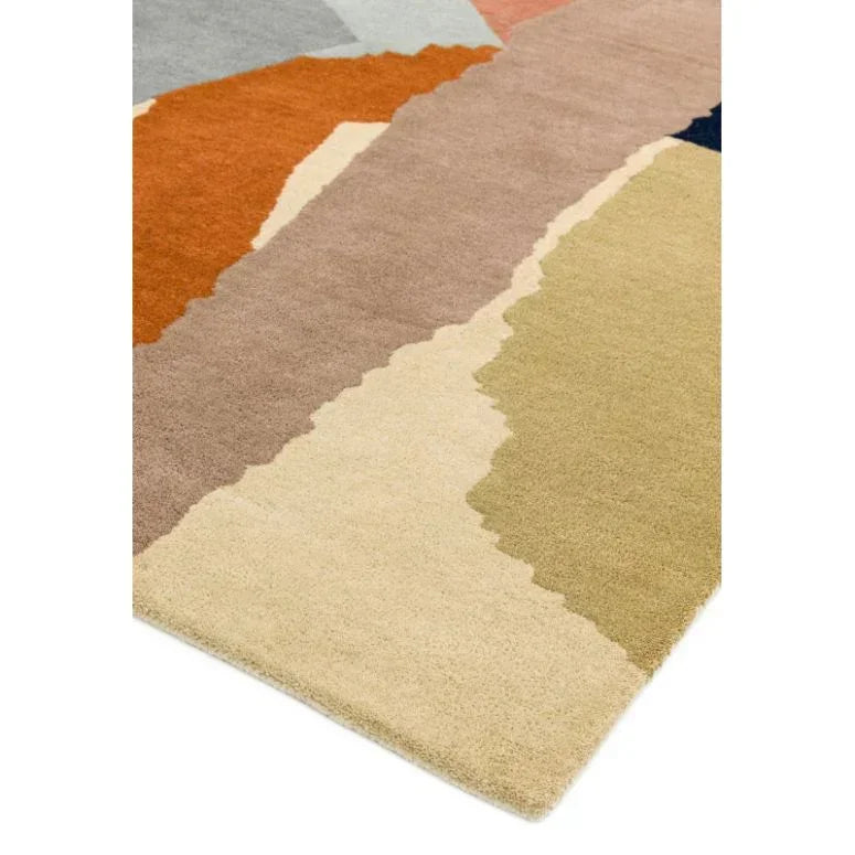 Modern geometric area rug with beige, tan, orange, and pastel color blocks