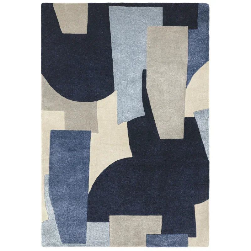Modern abstract rug with navy, beige, and blue geometric shapes on a rectangular pile