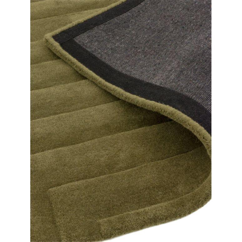 Olive green textured rug with visible non-slip backing and stitched border detail