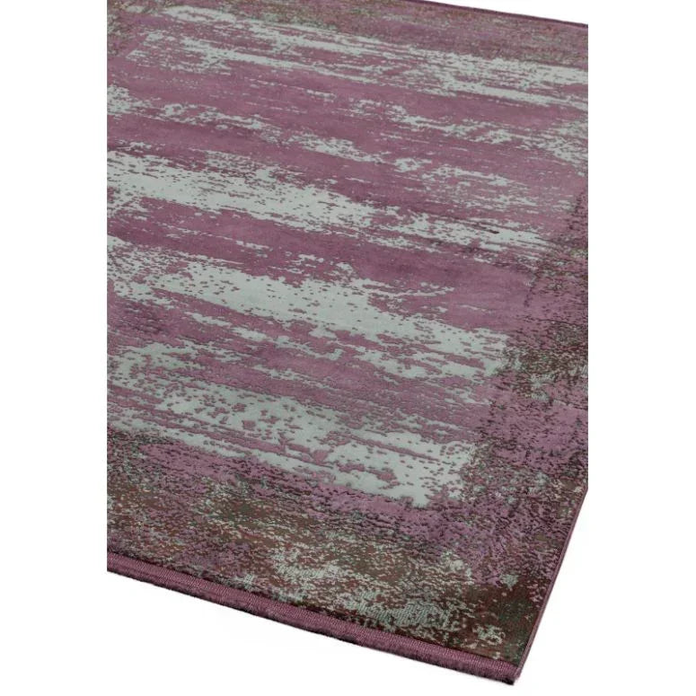 Rectangular purple and grey area rug with abstract pattern and stitched border