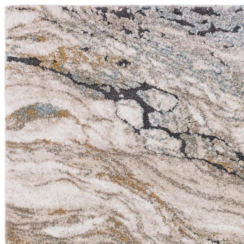 Abstract area rug in beige, grey, and gold with marble effect texture