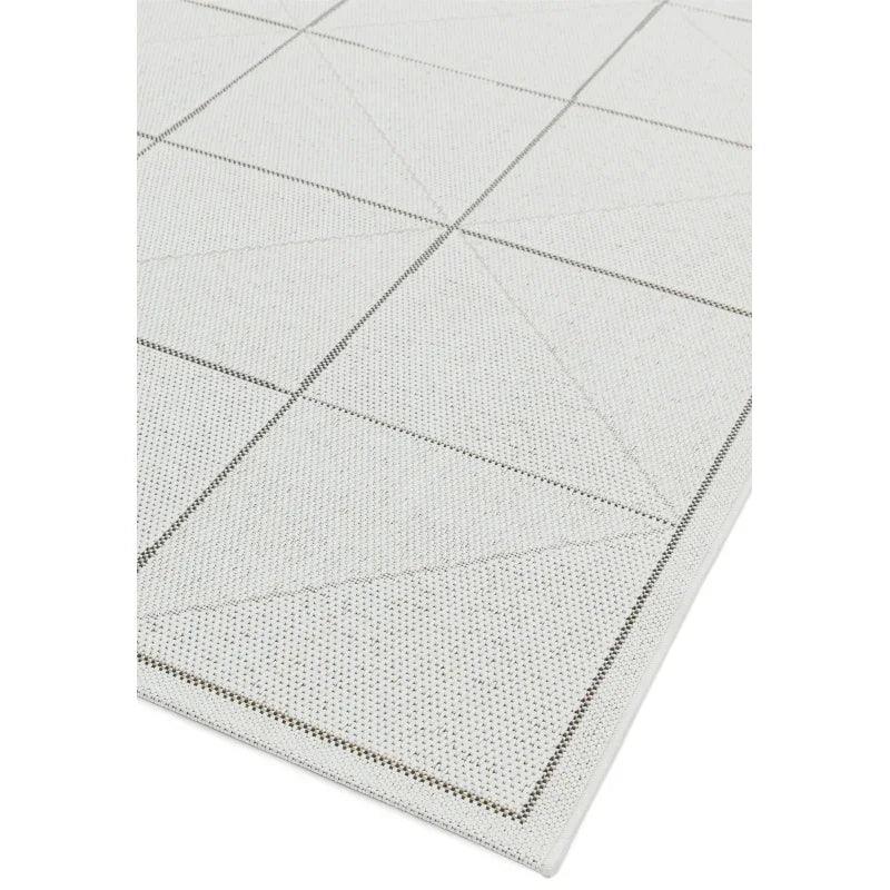 Light grey area rug with geometric line pattern and textured surface detail