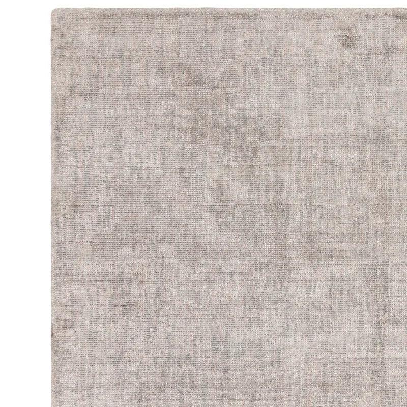 Light grey area rug with textured woven pattern, shown from overhead angle