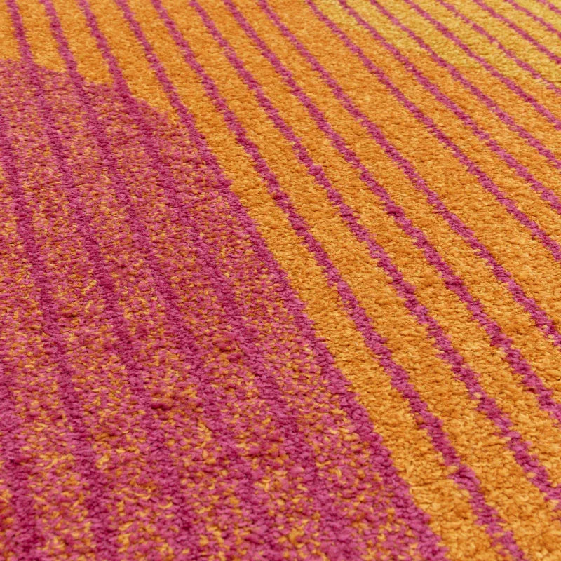 Orange and pink striped rug with textured pile, close-up of modern carpet design