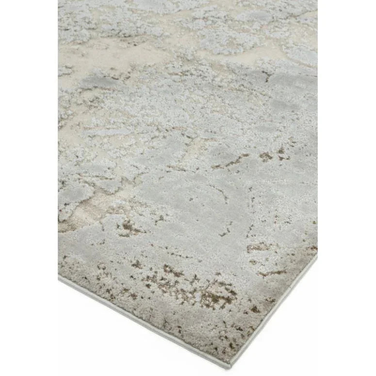 Modern area rug with distressed grey and beige pattern, close-up of corner